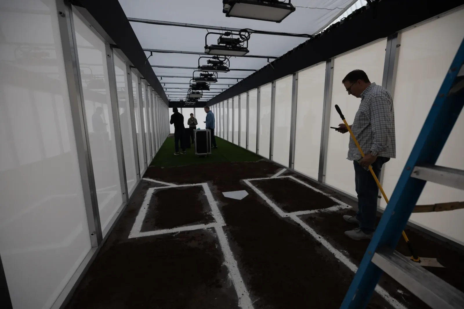 Inside the Smart Plexi® box with white panels and a batter's box