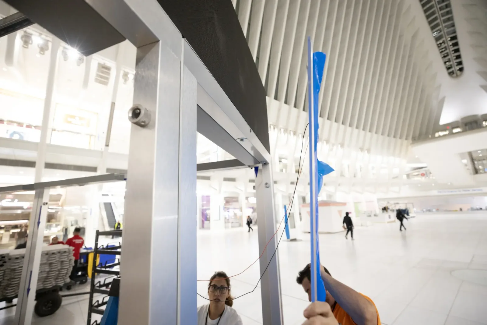 Installers set a Smart Plexi® panel into its frame and route the wire